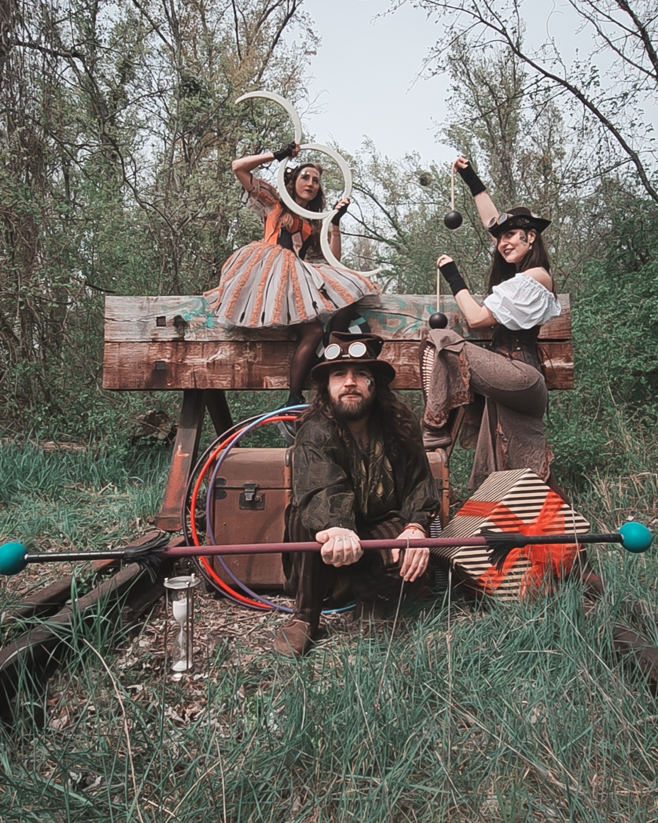 Steampunk trio with juggling props, hoops and staff in the woods