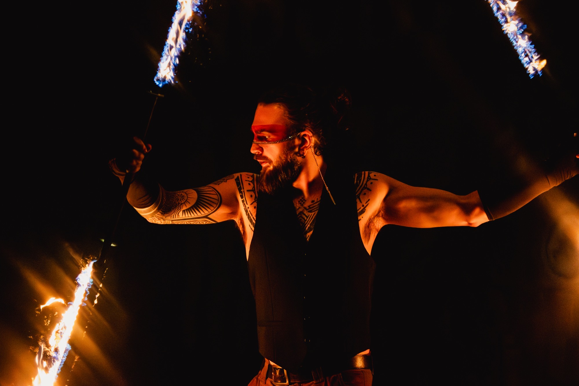 Joshua with burning fire staffs in the dark, arms outstretched